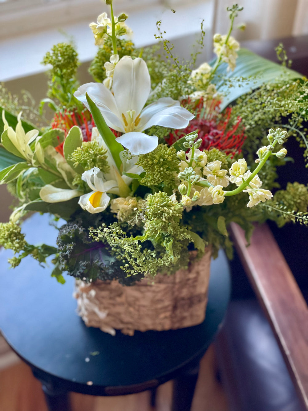 Birch seasonal arrangement of white flowers and greenery