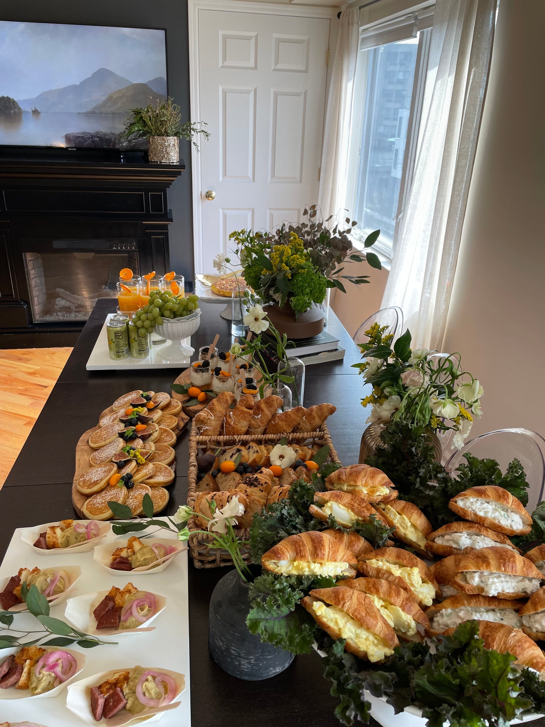 Styled Birch brunch grazing table with sandwiches and florals