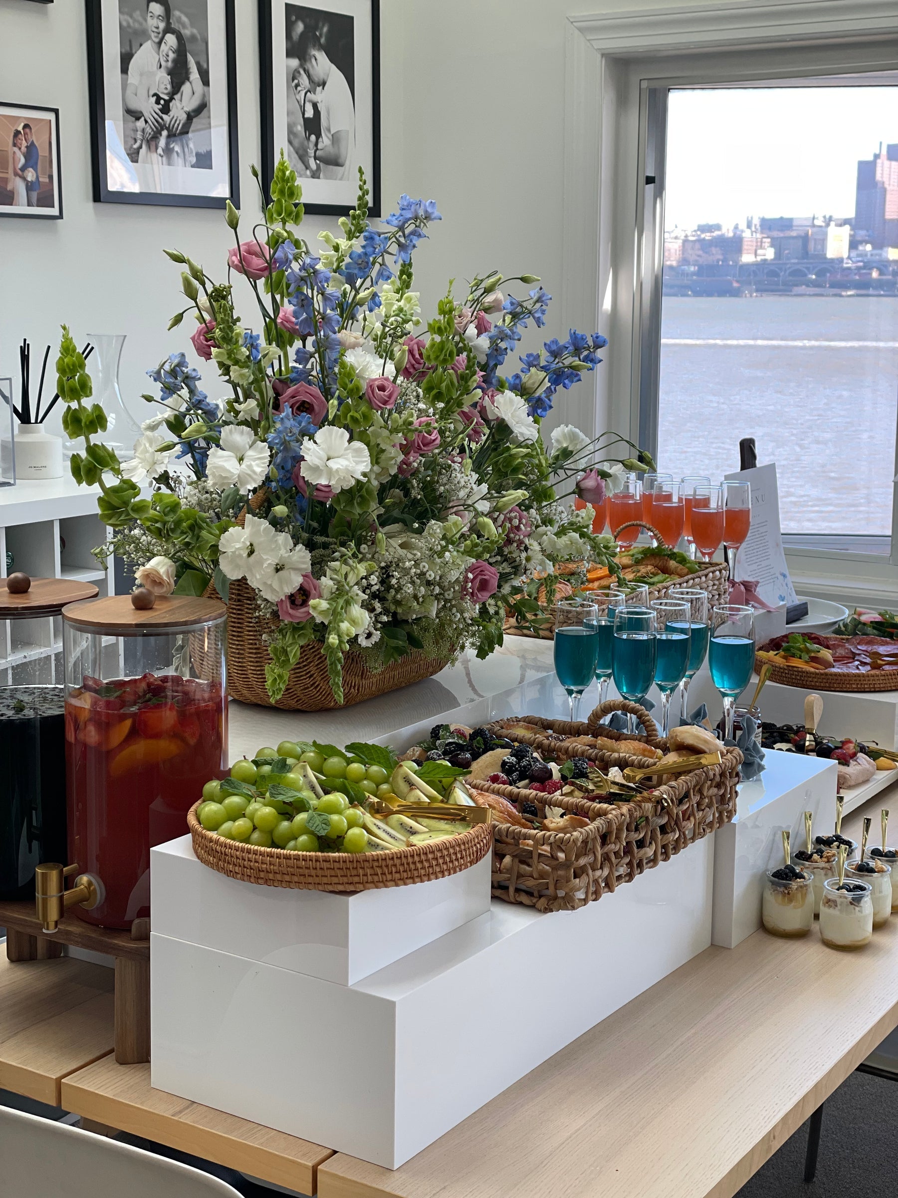 Birch catering display with abundant seasonal flowers and fresh salads